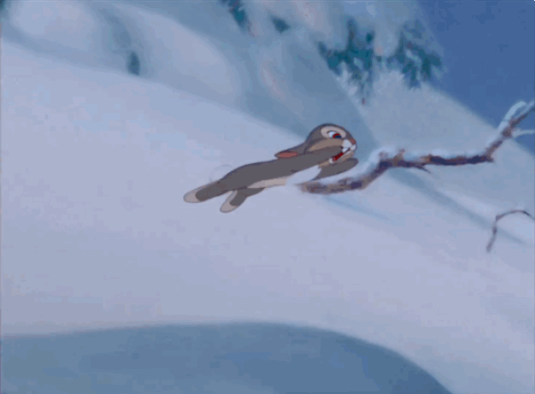 Смешная гифка зайчик прыгает в снег и катится по льду.