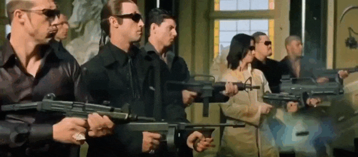 Смешной мем гиф, в Трампа стреляют из автоматов, а он останавливает пули рукой как в фильме "Матрица".