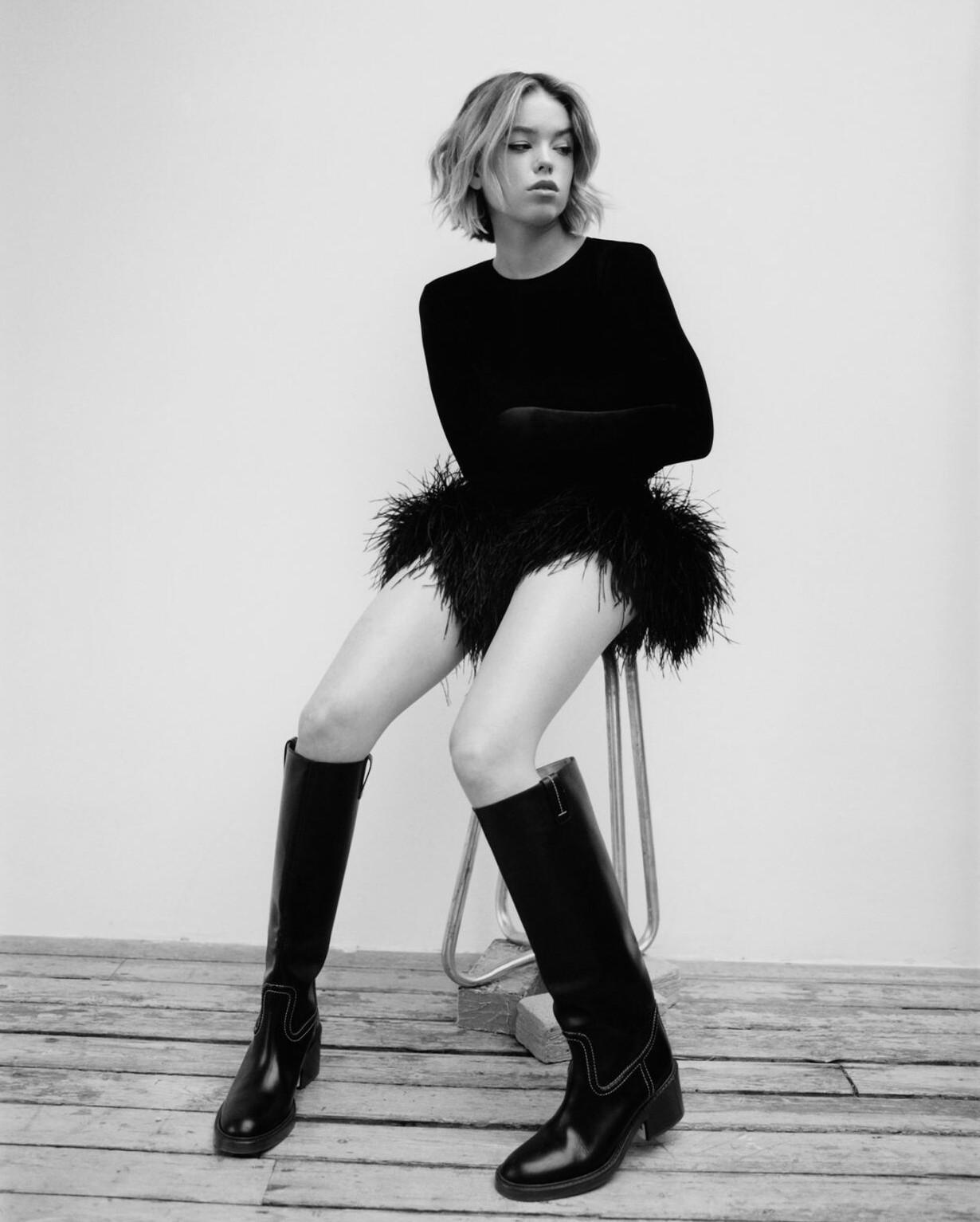 Смешное фото Милли Олкок на банках с краской, в белой майке, мини шортах и чёрных гольфах. Смешное фото Милли Олкок на банках с краской, в белой майке, мини шортах и чёрных гольфах.